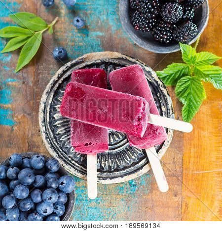Fresh summer wild blueberries and brambleberry home made sorbet ice cream popsicles.