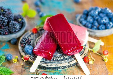Fresh summer wild blueberries and brambleberry strawberry and home made sorbet ice cream popsicles.