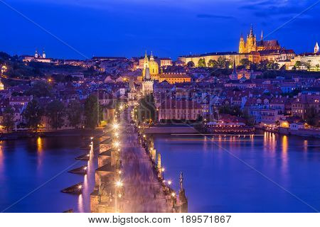 View of Charles Bridge, Prague Castle and Vltava river in Prague, Czech Republic during blue hour.