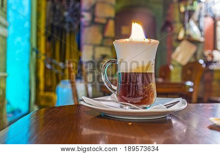 LVOV UKRAINE - MAY 16 2017: The numerous cafes bars and coffee houses of old town try to attract visitors with some uniquedishes or beverages one of them offers the burning coffee on May 16 in Lvov.