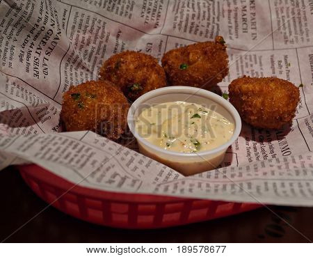 Hush puppies and creamy dipping
Hush puppies from balls of cornmeal deep fried and served in a tray with creamy dipping