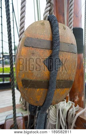ancient wooden sailboat pulley on an old restored dutch VOC ship