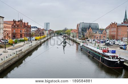 BYDGOSZCZ, POLAND. 8th APRIL 2017. The tightrope-walker sculpture over the River Brda is one of the many cultural attractions that are pulling tourists into the cit of Bydgoszcz in ever greater numbers.