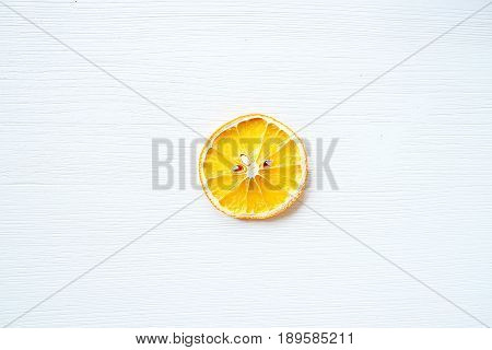 Slice of dried bright orange on a white background