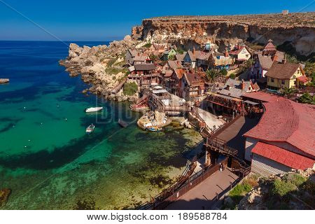 Traditional colorful houses in the famous Popeye Village at Anchor Bay, Il-Mellieha, Malta