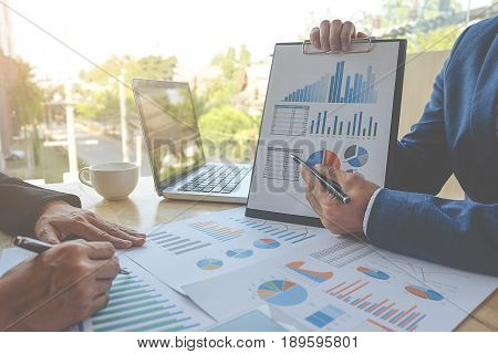 Business concept. Business people discussing the charts and graphs showing the results of their successful teamwork.