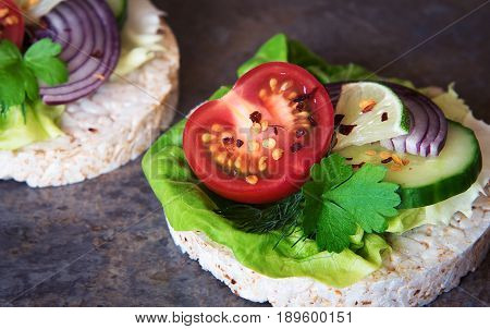 Healthy food - sandwiches rice cakes with lettuce tomato cucumber onion and parsley. rice crackers