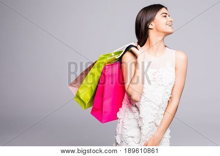 Shopping Woman Holding Bags, Isolated On Gray Background.