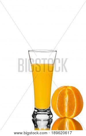 glass of orange juice and sliced orange mirror reflection isolated background