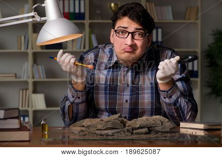 Archeologist working late night in office