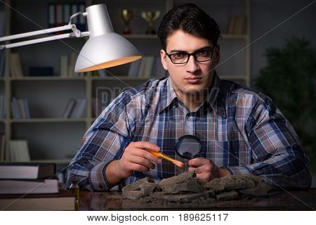 Archeologist working late night in office