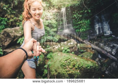 Male and woman couples asia. Walking hand travelers travel nature Forests mountains waterfalls. puhinrongkla romklao-paradorn waterfall