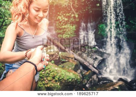 Male and woman couples asia. Walking hand travelers travel nature Forests mountains waterfalls. puhinrongkla romklao-paradorn waterfall