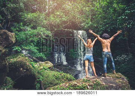 Male and woman couples asia. Walking hand travelers travel nature Forests mountains waterfalls. puhinrongkla romklao-paradorn waterfall