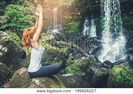woman asia travelers travel. Walking hand travelers travel nature Forests waterfalls. puhinrongkla romklao-paradorn waterfall. Meditate on yoga