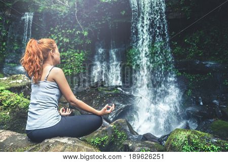woman asia travelers travel. Walking hand travelers travel nature Forests waterfalls. puhinrongkla romklao-paradorn waterfall. Meditate on yoga