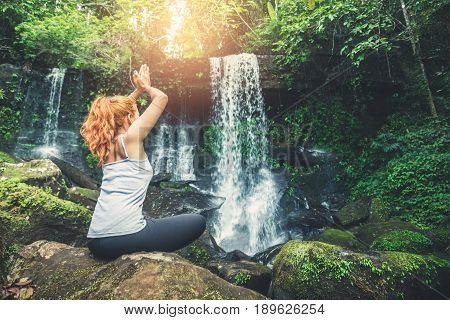 woman asia travelers travel. Walking hand travelers travel nature Forests waterfalls. puhinrongkla romklao-paradorn waterfall. Meditate on yoga