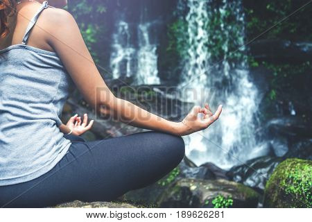 woman asia travelers travel. Walking hand travelers travel nature Forests waterfalls. puhinrongkla romklao-paradorn waterfall. Meditate on yoga