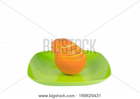 Orange slices on green plate isolated background