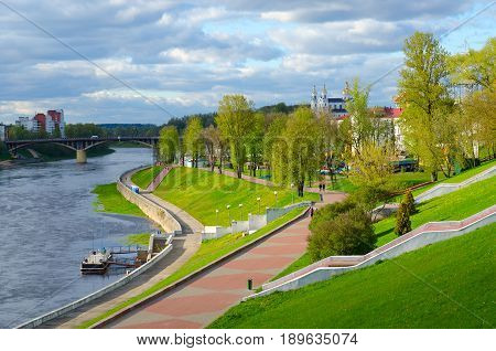 VITEBSK BELARUS - MAY 16 2017: Beautiful view of embankment of Western Dvina River Kirovsky Bridge and Holy Dormition Cathedral in May Vitebsk Belarus