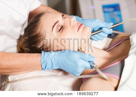 Conceptual beauty and cosmetology image of the hands of several beauticians holding their respective equipment. Beauty concept. Cosmetology concept. Cosmetology salon. Cosmetic procedures mesotherapy.