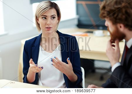 Young newscaster sharing latest news with colleague