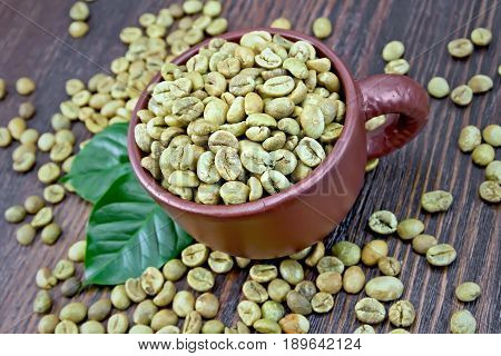 Coffee Green Grain In Cup With Leaf On Board