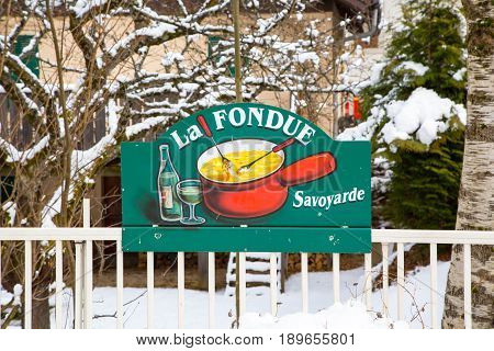Chamonix, France - January 21, 2015: La Raclette - traditional Savoyarde french meal sign near the restaurant