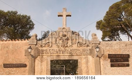 RANDA MALLORCA SPAIN - FEBRUARY 9 2013: Cross and entrance inscription on the monastery Cura on February 9 2013 in Randa Mallorca Spain.