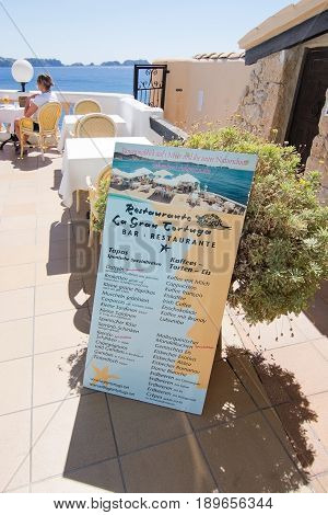CALA FORNELLS MALLORCA SPAIN - SEPTEMBER 6 2016: Tortuga restaurant menu information board and sea view on a sunny day on September 6 2016 in Cala Fornells Mallorca Spain.