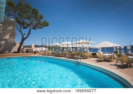 CALA FORNELLS MALLORCA SPAIN - SEPTEMBER 6 2016: Pool at The Grand Tortuga restaurant with ocean view on a sunny day on September 6 2016 in Cala Fornells Mallorca Spain.