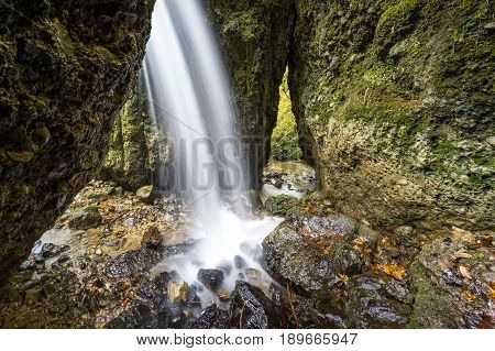Beautiful waterfall in a narrow gorge. Allgau Alps.