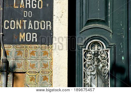 An old tradtional house with a weathered green door in Lisboa.