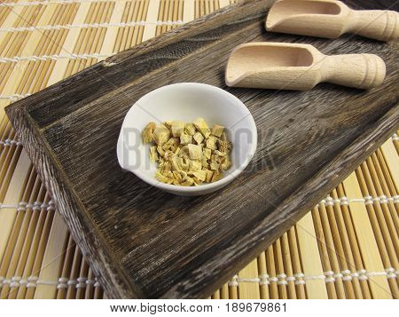 Liquorice root, Liquiritiae radix, in wooden tray