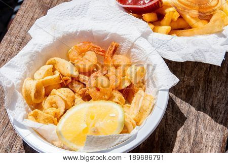 Crispy fresh squid and shrimp in white plate.The fried seafood food, cooked perfectly.