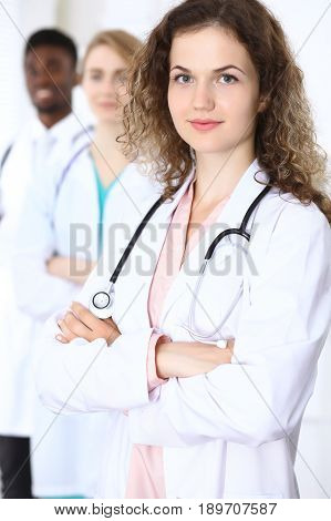 Happy doctor woman with medical staff at the hospital.