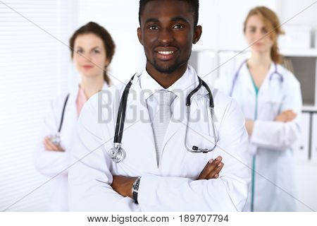 Happy african american male doctor  with medical staff at the hospital