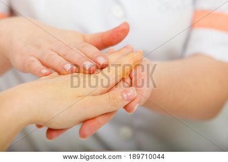 Handcare manicure and pedicure spa wellness treatment concept. Woman getting hand massage at beauty salon