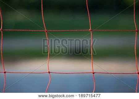 Red volleyball net with blurred background soft focus.