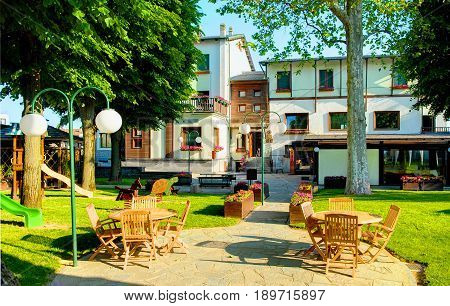 SAVIGLIANO, ITALY, MAY,25, 2010: Outdoor view on inner garden of the Grantbaita hotel and italian restaurant patio. Italy holidays vacations tours famous hotels restaurants. Outdoor restaurant dinner
