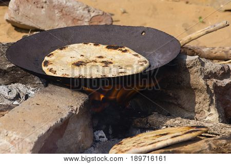 Indian chapatti on fire Pushkar India Close up
