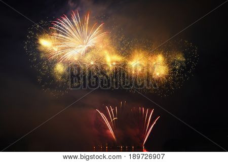 Beautiful colorful fireworks on the water surface with a clean black background. Fun festival and contest of Firefighters Brno Dam - Czech Republic.