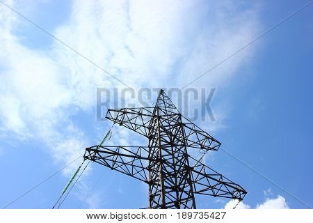 Transmission power tower electricity pylon over blue sky. Steel lattice tower used to support an overhead power line