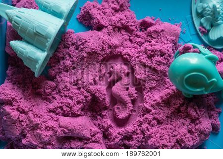 Sea horse shape stamped into the colorful kinetic sand