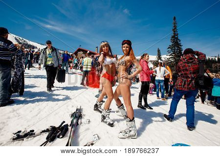 Sheregesh, Kemerovo region, Russia - April 16, 2016: Grelka Fest is a sports and entertainment activity for ski and snowboard riders in bikini.group of snowboarders friends in swimsuits.