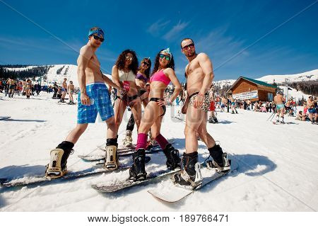 Sheregesh, Kemerovo region, Russia - April 16, 2016: Grelka Fest is a sports and entertainment activity for ski and snowboard riders in bikini.group of snowboarders friends in swimsuits.