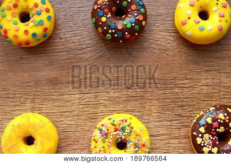 Six donuts composition on a wood background