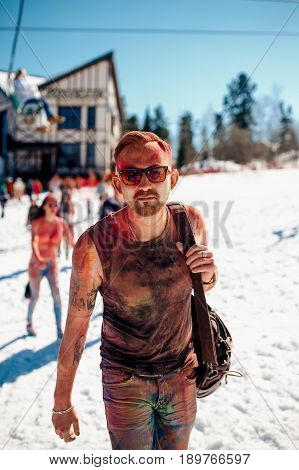 Sheregesh, Kemerovo region, Russia - April 16, 2016: Grelka Fest is a sports and entertainment activity for ski and snowboard riders in bikini. man in paints holi.
