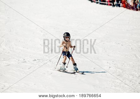 Sheregesh, Kemerovo region, Russia - April 16, 2016: Grelka Fest is a sports and entertainment activity for ski and snowboard riders in bikini.child descends from the mountain in shorts
