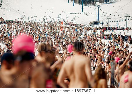 Sheregesh, Kemerovo region, Russia - April 16, 2016: Grelka Fest is a sports and entertainment activity for ski and snowboard riders in bikini. Command descent.